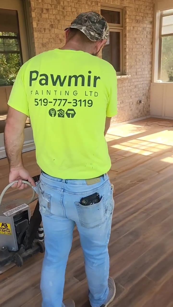 Pawmir painter on site in a company shirt
